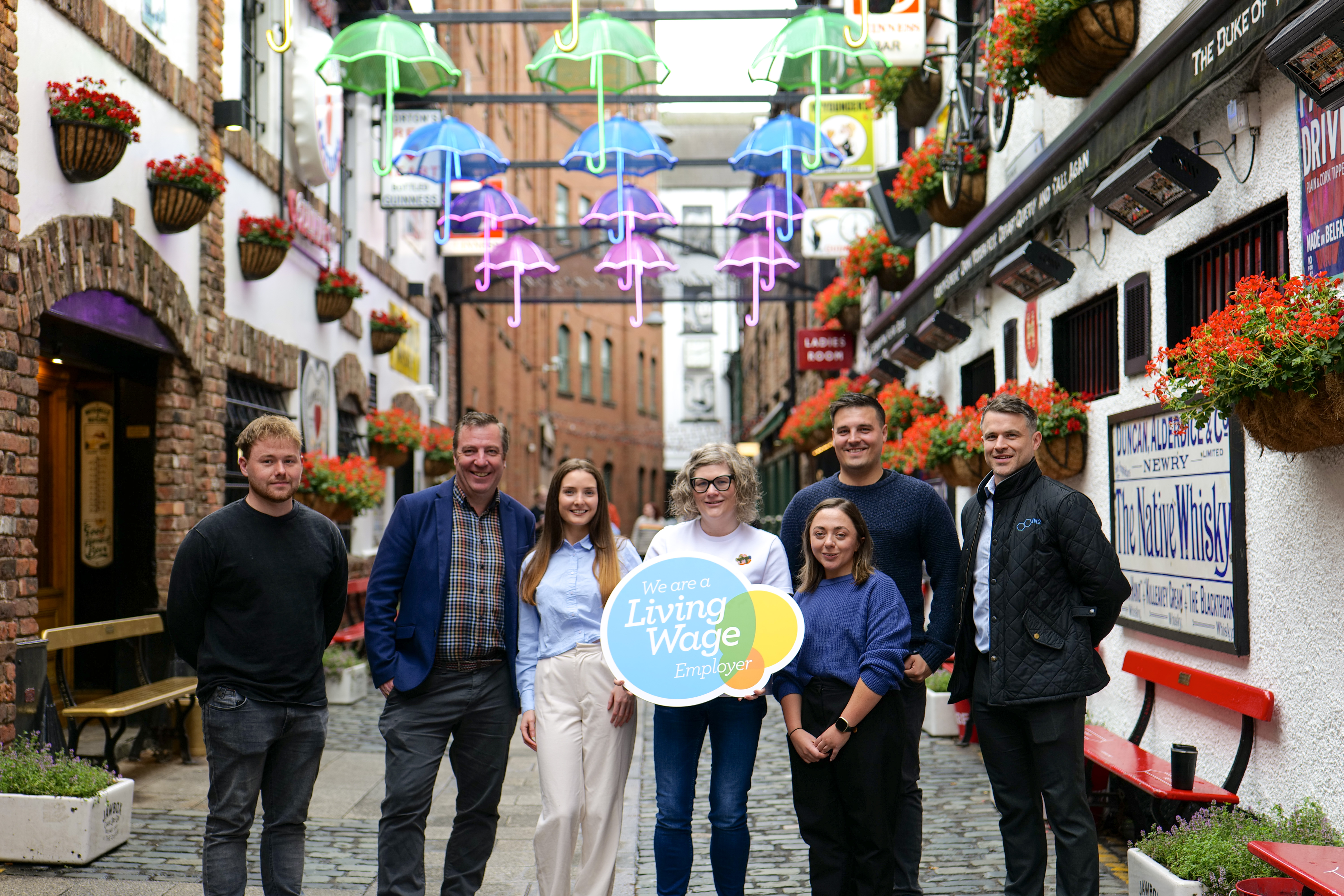 IN2 employees standing in the Cathedral Quarter in Belfast and looking at the camera.