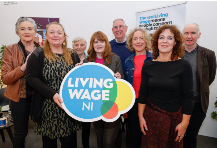 The Economy Minister, Dr Caoimhe Archibald, standing with Advice NI staff at the Imagine Festival in Belfast.